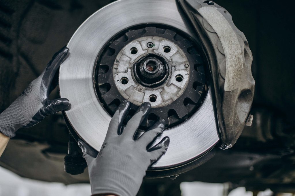 mechanic changing brake discs car service 1